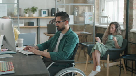 Middle-Eastern-Businessman-Sitting-in-Wheelchair-and-Working-on-Computer
